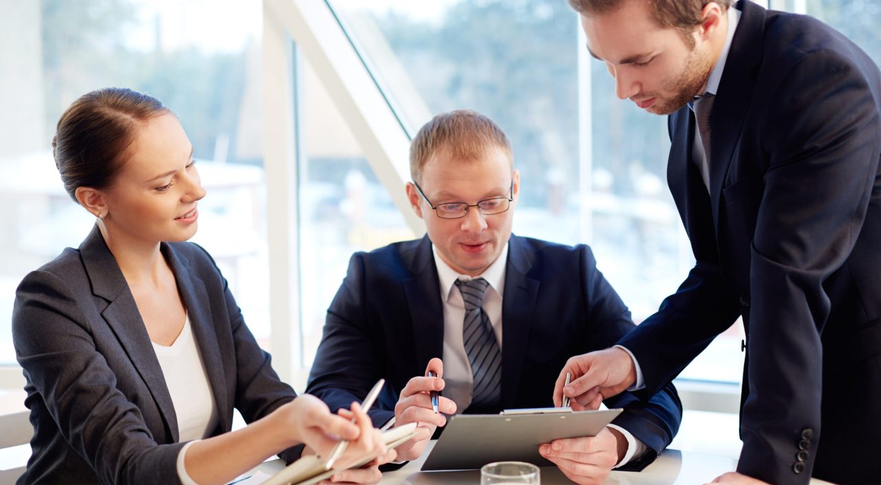 Group of confident business partners planning work at meeting